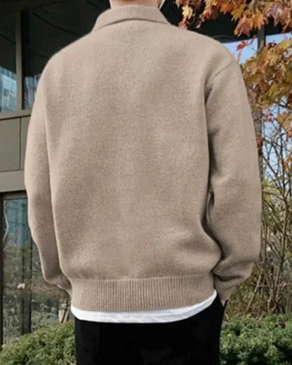 Wool sweater with buttons and half-zip closure.